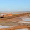 BHP ore train coming past the Solar Salt Farm at Port Hedland.