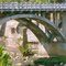 Open-spandrel concrete arch, 1927, & old pier from previous bridge