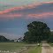 The Setting Sun Illuminates A Line Of Clouds