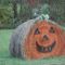 Hay bale decorated as a pumpkin