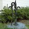 old well pump with broken pump handle, steadfast but deteriorating behind the out-of-service His Church in Knightdale, nestled in the weeds and unchecked growth of late summer, with the sparkler-like seedheads of crabgrasses dancing around its base, 9-2-11