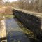 Along an abandoned canal, one sees abandoned locks. Ohio & Erie Canal Towpath Trail, north of Clinton, Ohio.
