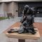 Mom and children reading, life size bronze by Greg Todd, in front of library, Goodland, KS