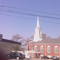 Quincy Point Congregational Church steeple with man on ladder