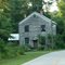 charmingly run-down old house at a bend in the road in Macon, NC, swathed in the lush, overgrown weedy foliage of summer, 7-27-11