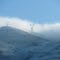 High voltage transmission lines shrouded in clouds.  Dec-30-2009