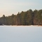 Red Boathouse on Frozen Lake