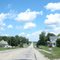 Fluffy clouds looking east on US 136 toward Brownville - July 2010