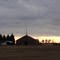 Grace Christian Fellowship Church, under a high gray sky with the sun starting to set through clearing on the horizon, 1-24-11