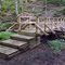 FLT M22 10.1 mi - Bridge, 20' long, 2x8x44 deck boards, telephone pole stringers, 4x4 verticals, 2x4 rails, stacked 6x6 sills (one rock filled), 4 steps, 4' to drainage