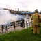 Boat Fire, Columbia River. The fire department sprays foam on a burning boat at St. Helens, Oregon.