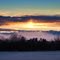 Fog rises in the East Gallatin Valley, as the sun sets behind the Tobacco Root Mtns.